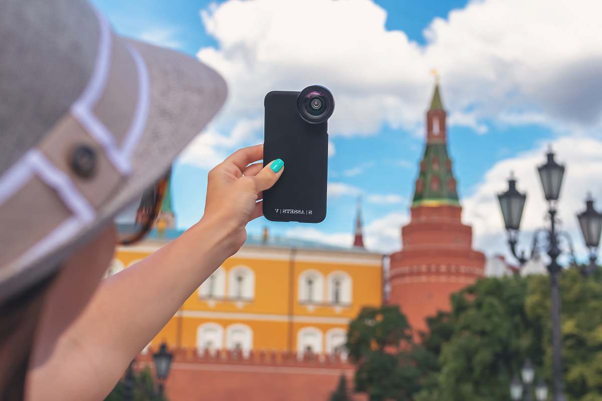 cell phone woman holding phone while taking picture mobile phone